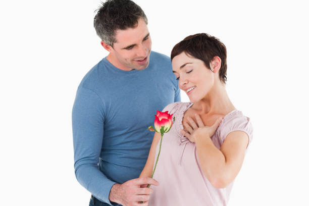 istock Husband offering a rose to his smiling wife 855543774