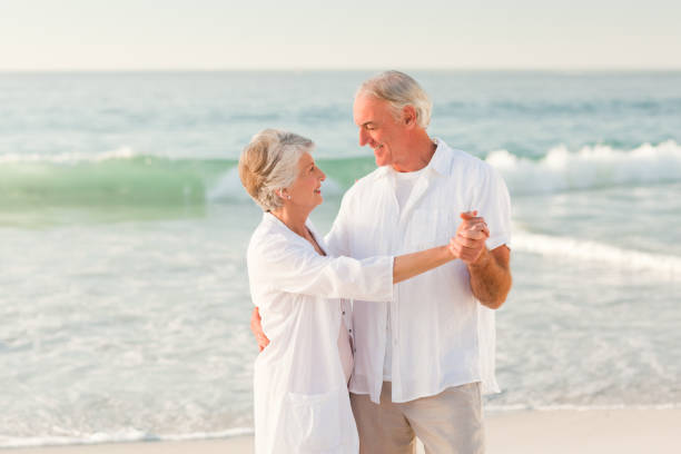 istock Elderly couple dancing on the beach 855543896