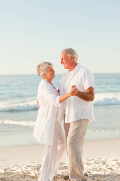 istock Elderly couple dancing on the beach 855543970