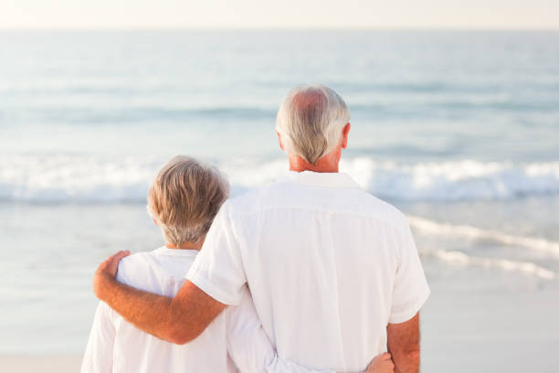 istock Man hugging his wife on the beach 855544196