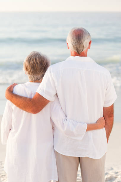istock Man hugging his wife on the beach 855544208