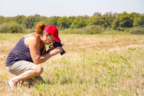 istock Woman photographer shoots nature 855546840