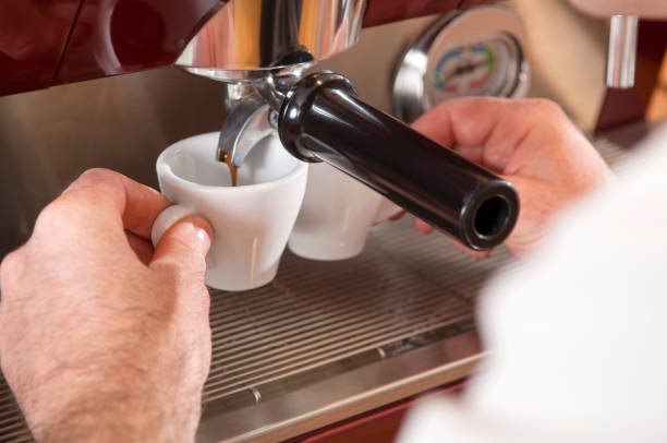 istock Barista Hands Touching Cups on Espresso Machine Dripping Fresh Coffee 855551374