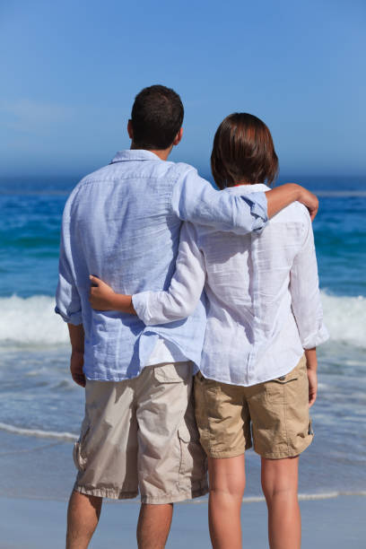 istock Enamored couple looking at the sea 855553700