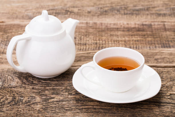 istock Image of ivory tea cup with kettle on wooden palette 855554414