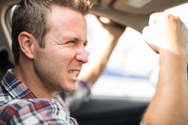 istock Irritated young man driving a car. Irritated driver 855554618