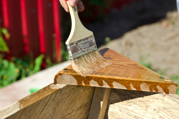 istock The man works with a brush, cover the varnish tree. 855561004
