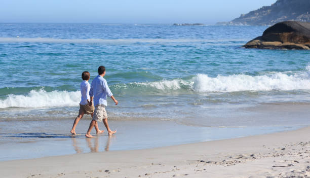 istock Couple walking on the beach 855563334