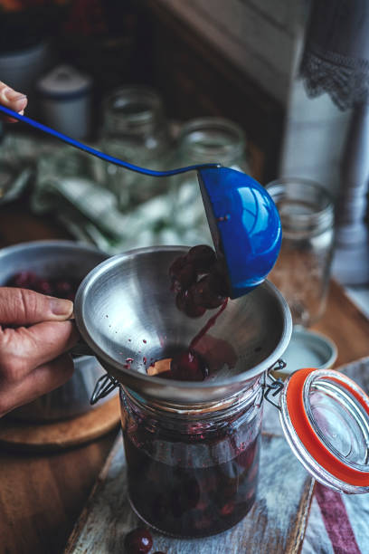 istock Preparing Homemade Cooked Cherries and Canning in Jars 855563810