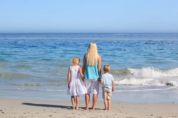 istock Joyful family walking on the beach 855563848