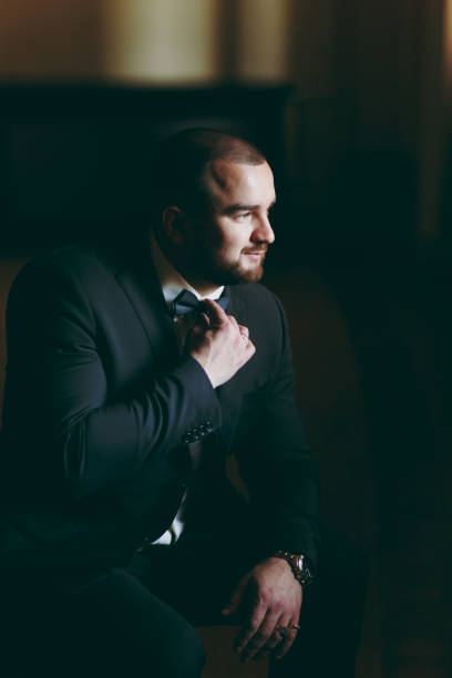 istock Groom in a suit and a bow tie for a walk 855564994
