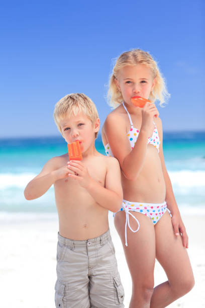 istock Brother and sister eating an ice cream 855567890