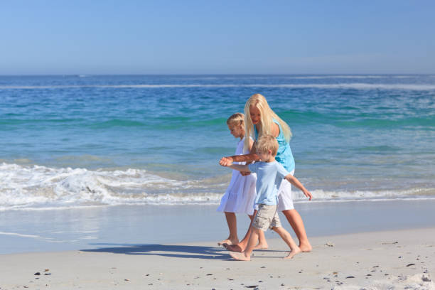 istock Family walking on the beach 855570684