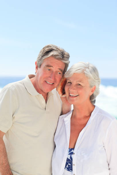 istock Retired couple listening to their shell 855574154