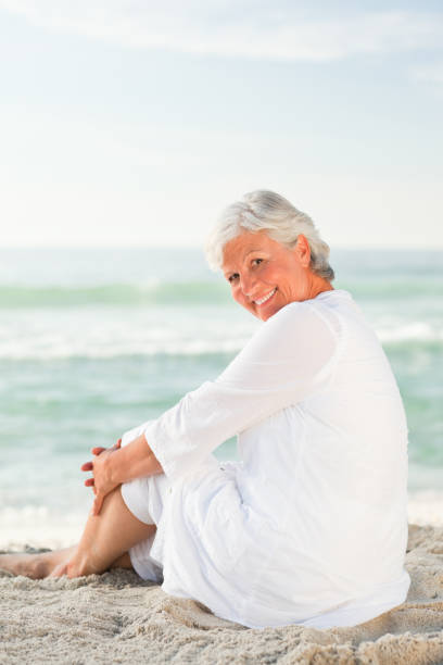 istock Woman who is sitting on the beach 855581568