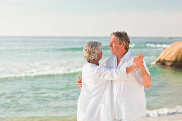istock Elderly couple dancing on the beach 855581726