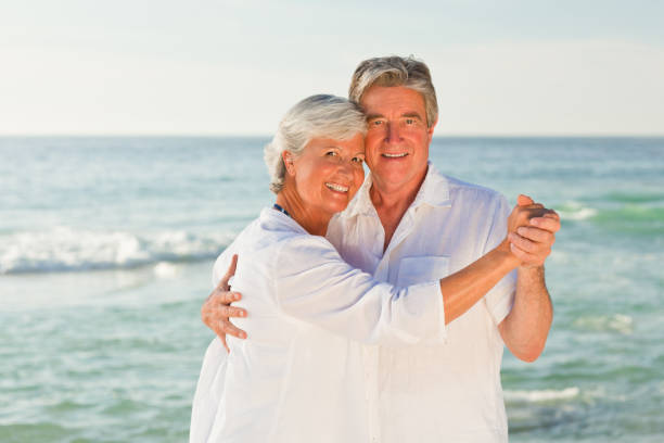 istock Mature couple dancing on the beach 855581992