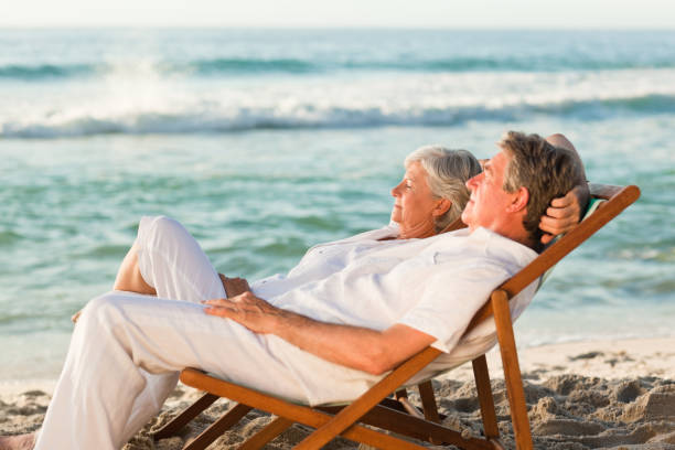 istock Elderly couple relaxing in their deck chairs 855584906