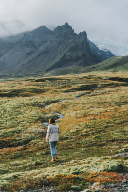 istock Woman looking at the  glacier in mountains 855587366