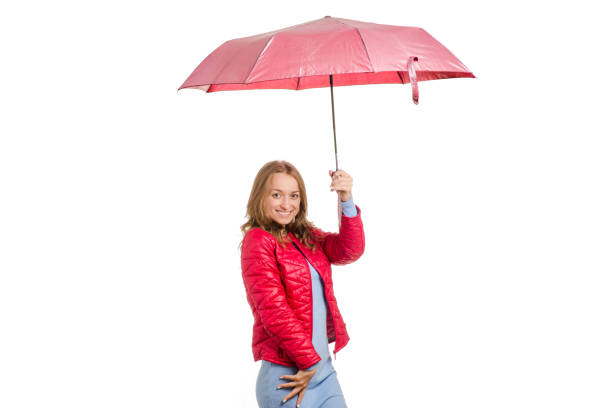 istock Young woman in a jacket with an umbrella rain 855590618