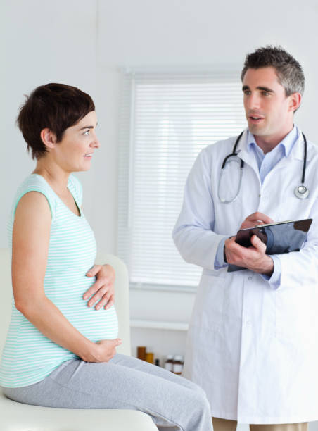 istock Sitting Pregnant woman touching her belly 855590810