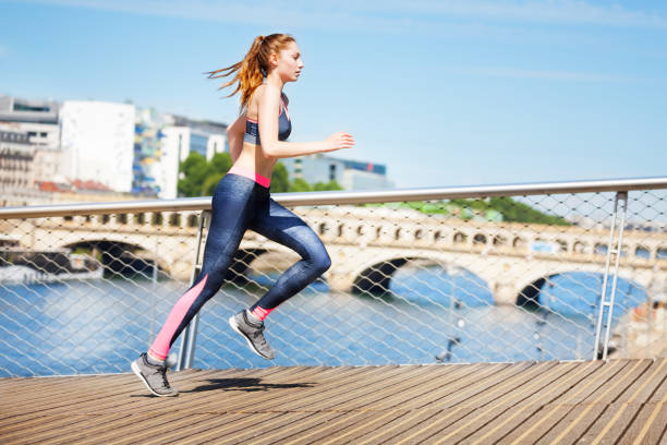 istock Sporty young woman on morning run 855590914