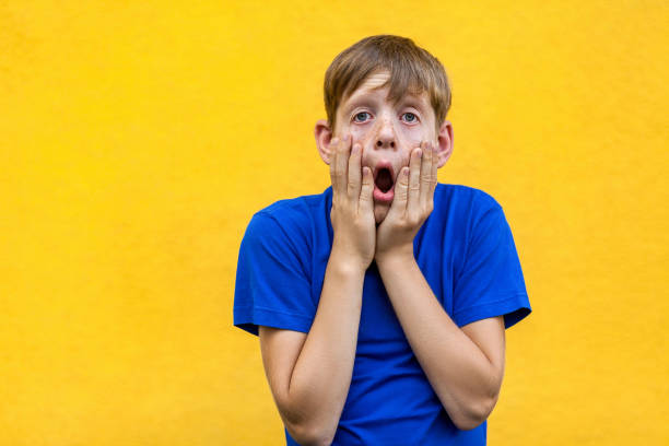 istock So boring. Alone sad boy looking and camera with open mouth. 855597232