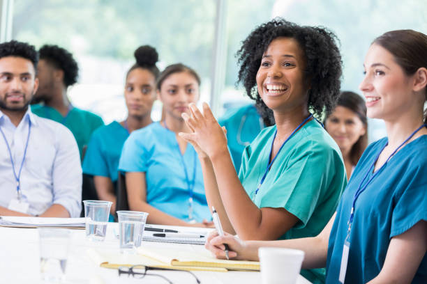 istock Cheerful nursing student attentively listens to professor's lecture 855597384