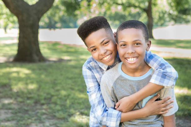 istock Cheerful brothers bond while playing in the park 855600892