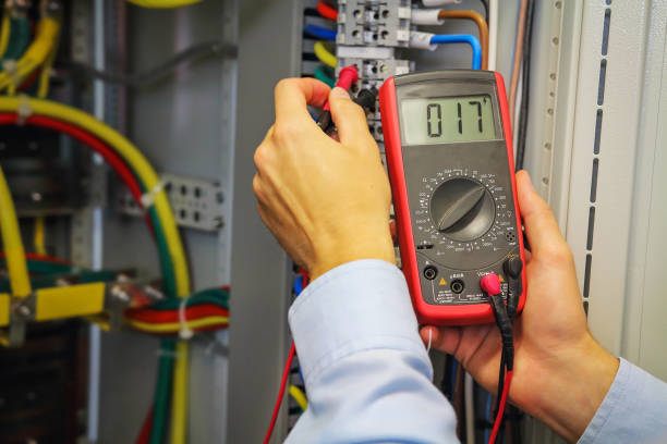 istock Multimeter in hands of electrician. Engineer adjust electric panel. 855600960
