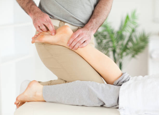 istock Masseur massaging a female customers foot 855601098