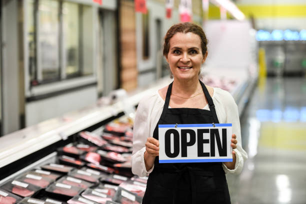 working at the supermarket meat department - supermarket meat store manager imagens e fotografias de stock