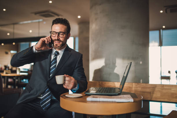 istock Businessman talking on mobile phone in cafe 855608654