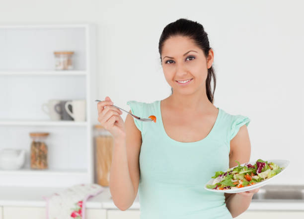 istock Cheerful young woman with salad 855611372