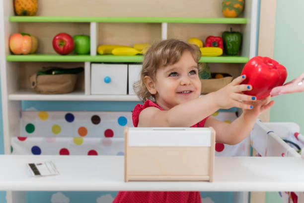 A little girl playing with toys stock photo