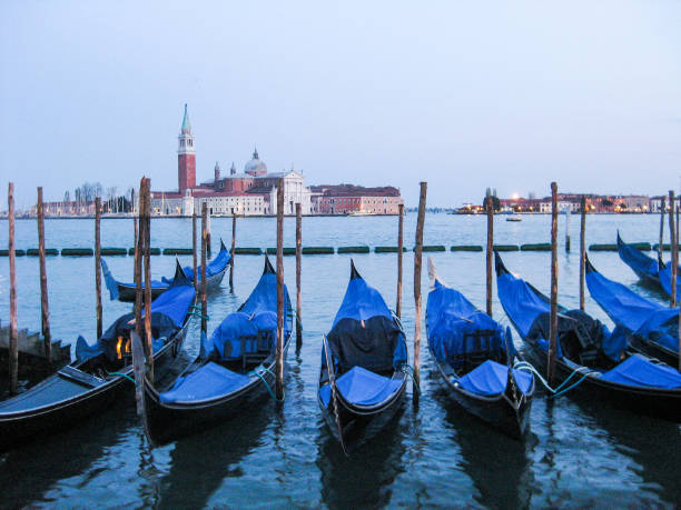 istock Gondolas on the embankment in Venice 855617898