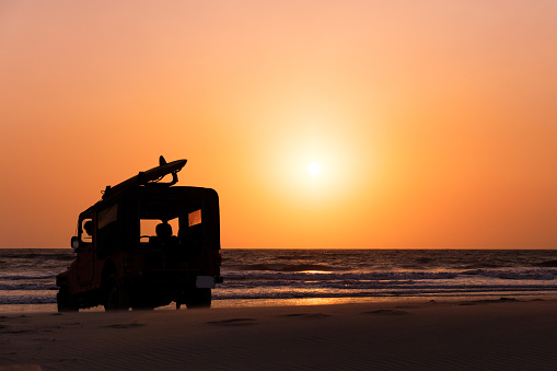 Surf rescue vehicle on beach at sunset, Goa, India