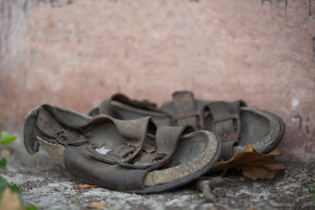 istock Old pilgrim sandals abandoned on a stone monument 855625584