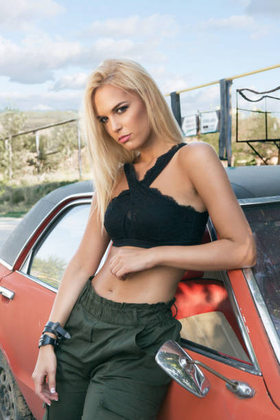 istock Woman model standing by vintage car 855628666