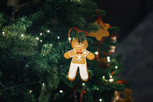 istock Gingerbread man hanging on decorated Christmas tree 855632080