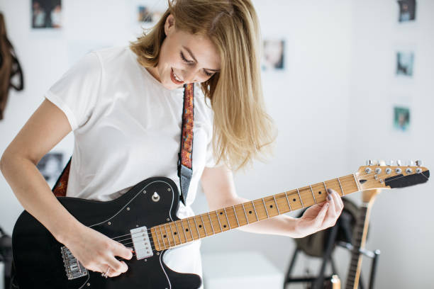 istock Blond girl playing guitar 855637980