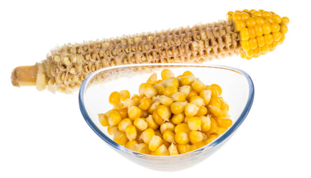 Yellow boiled corn isolated on white background Partly eaten corncob and pile of corn grains in glass bowl corn cob eaten stock pictures, royalty-free photos & images
