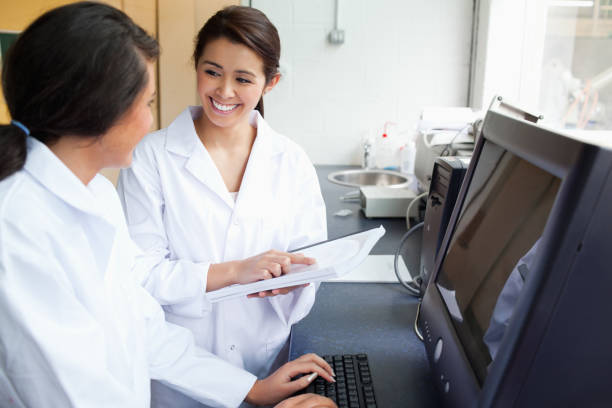istock Smiling scientists working with a monitor 855644982