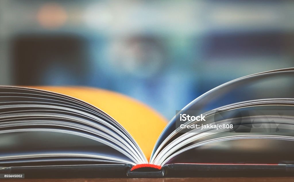 Education and business background Open book on working desk in the library room with blurred focus for business and education background Article Stock Photo