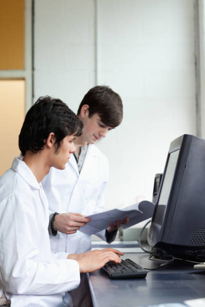 istock Male scientists using a monitor 855647178