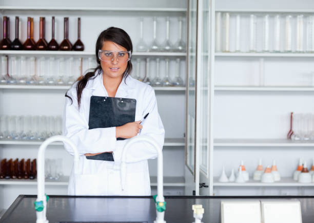 istock Female scientist holding a clipboard 855648076