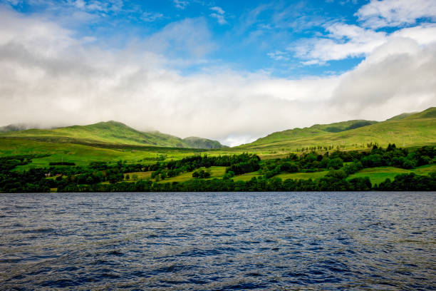 Green grass hills slopes landscape at Loch Tay near Killin village in central Scotland stock photo