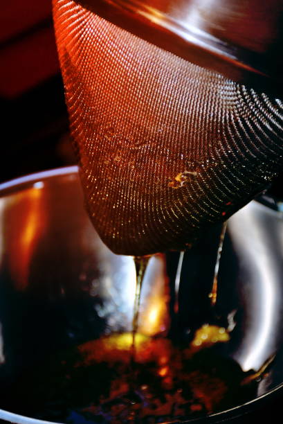 Extracting Honey from Honeycomb Extracting Honey from Honeycomb in Honey Frame. beehive new zealand stock pictures, royalty-free photos & images