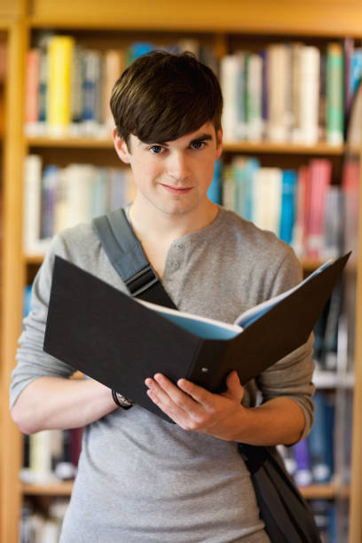 istock Portrait of a smiling student holding a binder 855660774