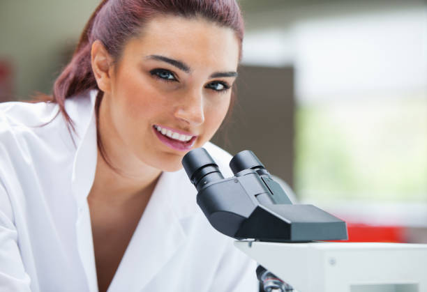 istock Close up of a scientist posing with a microscope 855663754